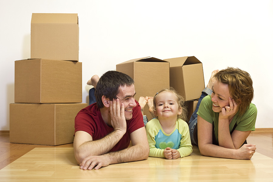 family with boxes smiling